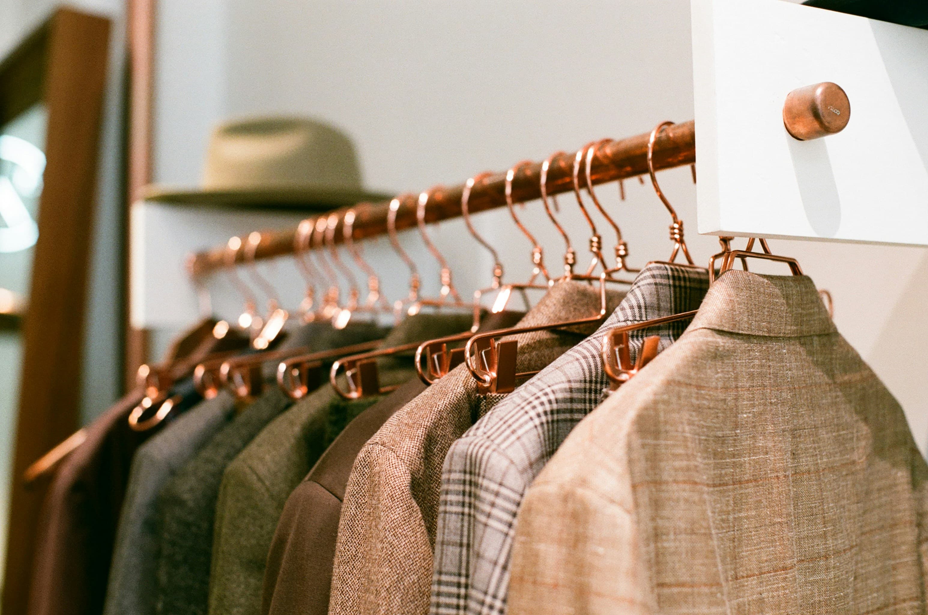 Tailored jackets hanging in a private atelier